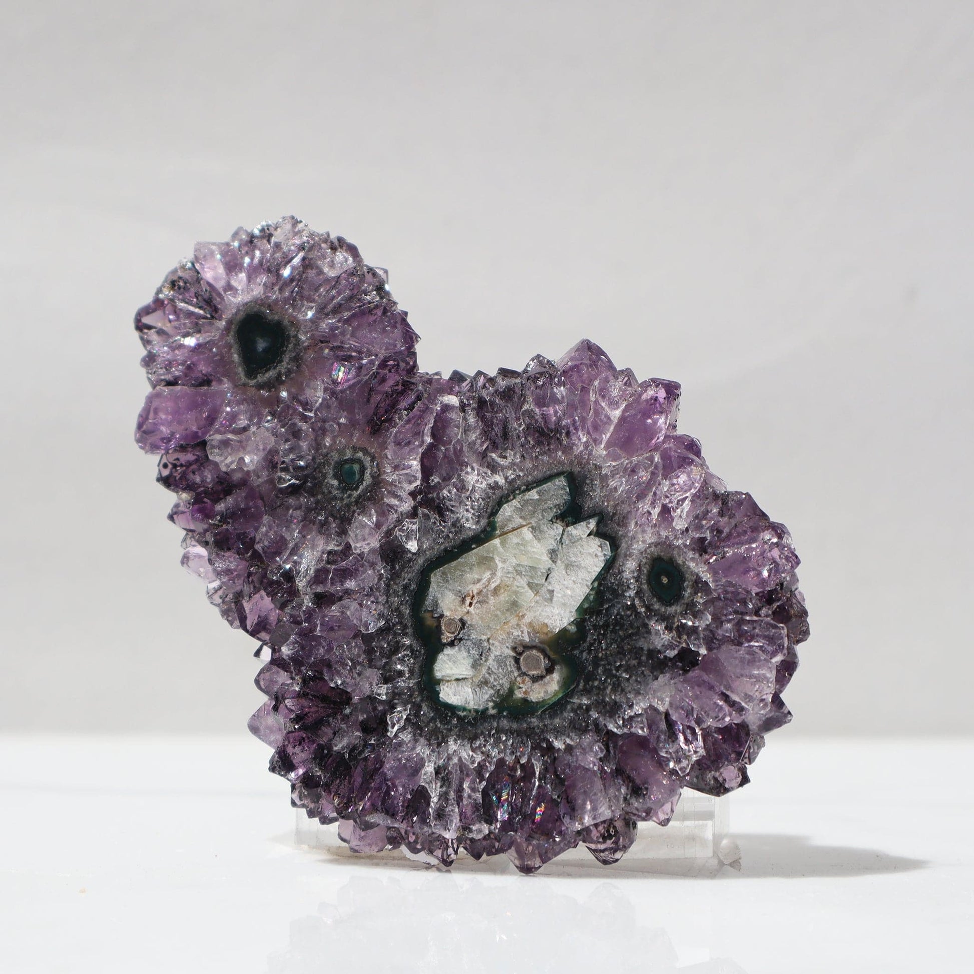 Rare in its mineral composition, this large stalactite slice of multiple stalactites in one, offers no trace of visible white quartz, instead, it displays saturated purple color crystals and dark green jasper,.