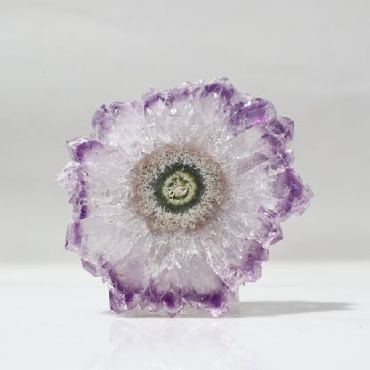 This gorgeous amethyst flower-resembling stalactite perfectly fits the definition of translucent yet intense beauty, displaying a center of cream color agate and green jasper with luminous lavender crystal peaks.   