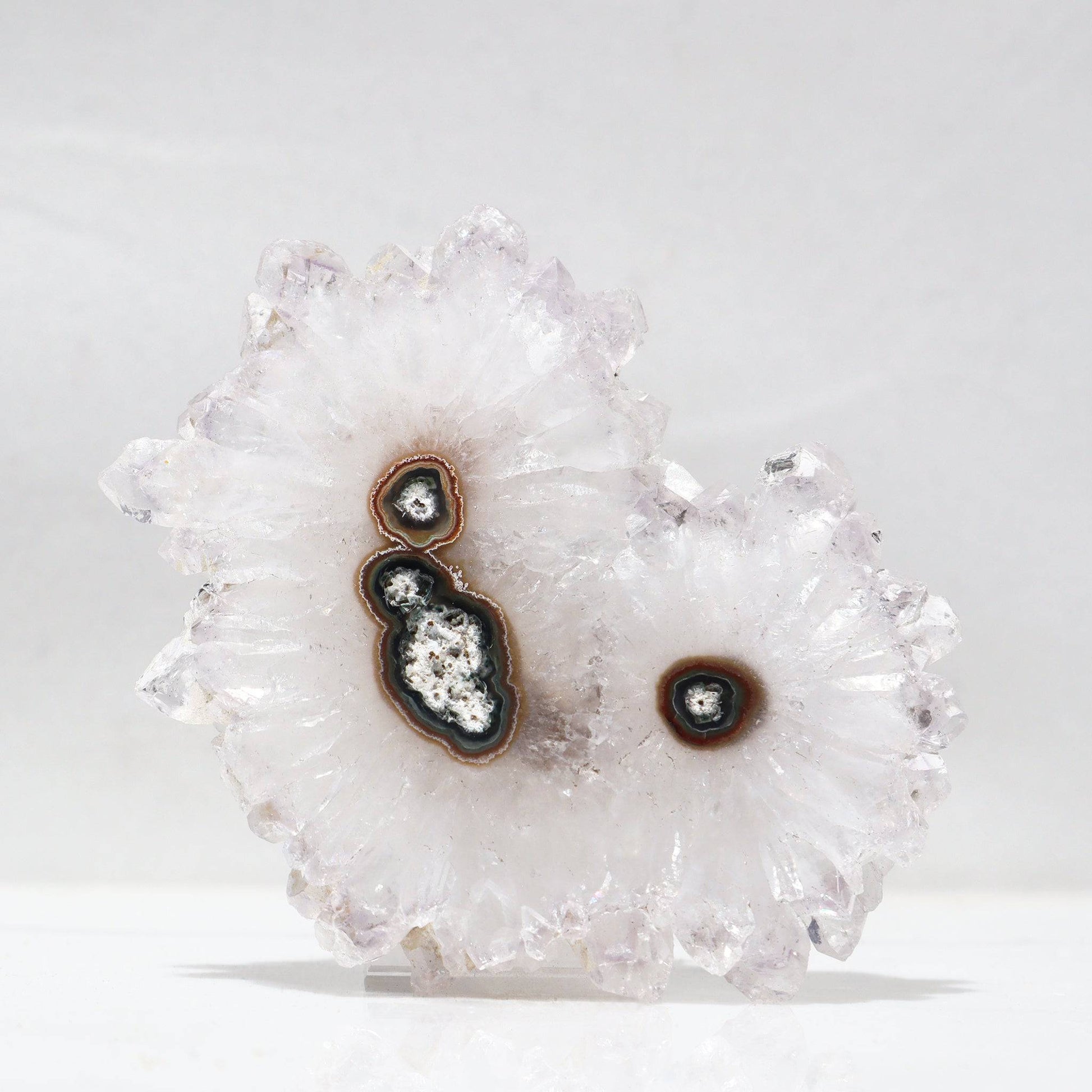 Snowy-winter inspiring, and stunning triple amethyst stalactite formation. This mineral flower piece offers multiple stalactite centers of brown and green agate as the white quartz crystals are pure see-through white.