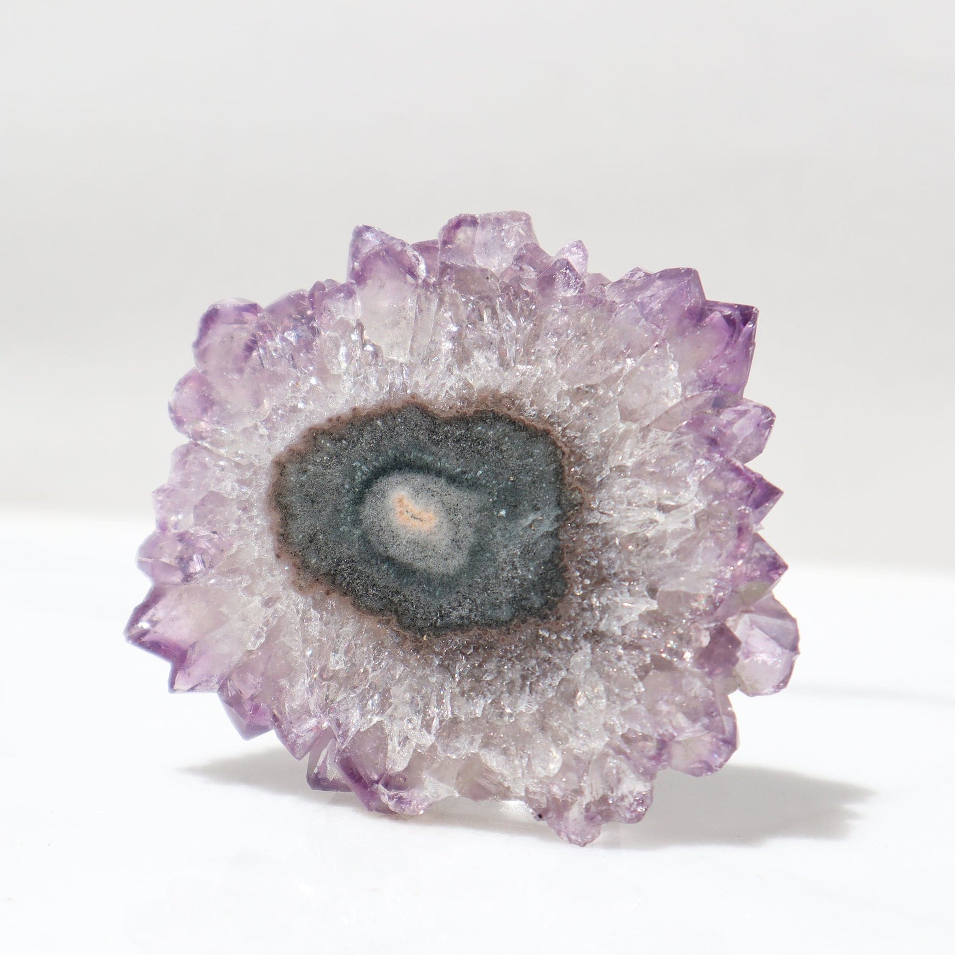 Stalactite flower formed of a bluish-green agate center and divine purple quartz, with yet more intense purple color on its peaks, it was polished to perfection by experienced locals in Uruguay to reveal it all.    