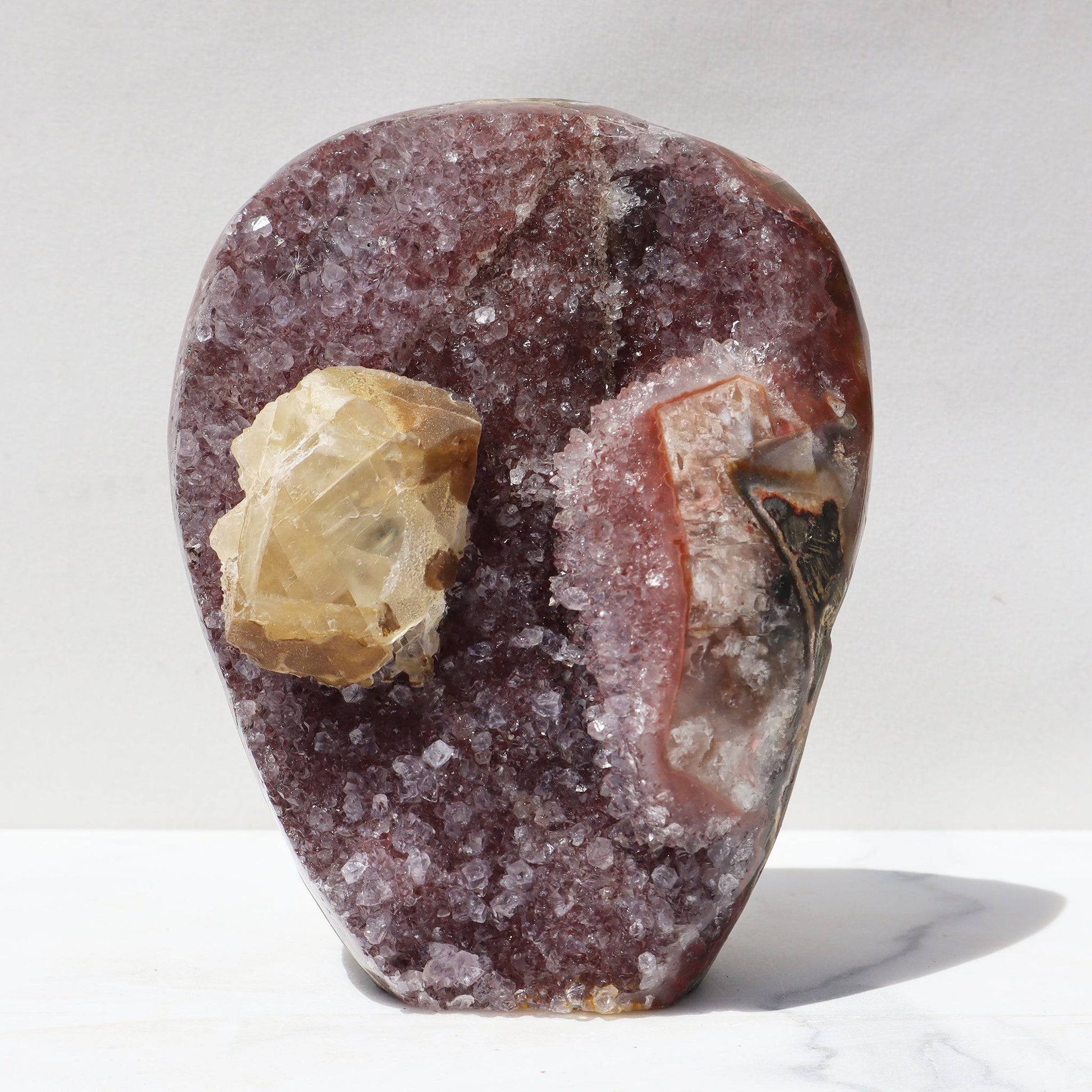 Rare, for amethyst lovers with a craving for an untraditional color. Earthy bands of red agate meet the orange-brown quartz crystals. Rich yellow calcite.