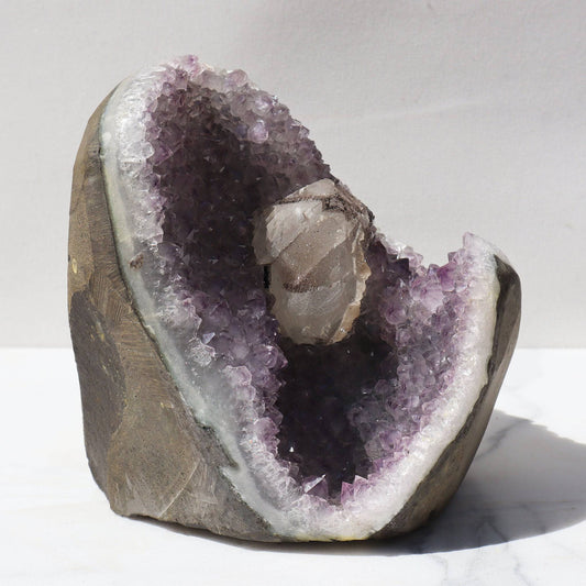 Impressive, undulating white quartz edge, lavender amethyst. Icy calcite resembles a flower with details of black goethite. Ethically sourced from Uruguay.