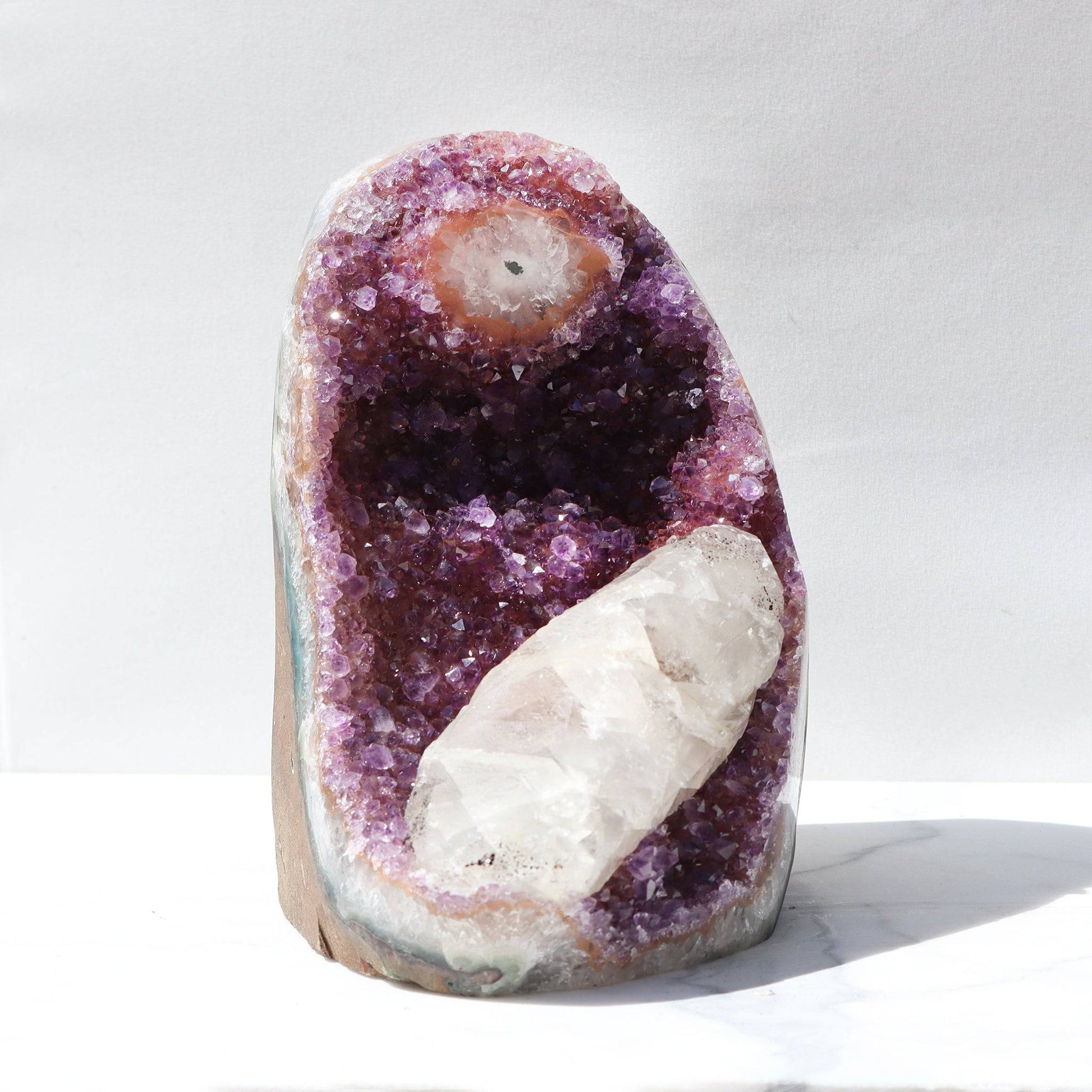 Distinctive tones of purple, pink, orange, and red on this rare amethyst piece. This mineral masterpiece was naturally formed with a huge calcite formation. Stunning large cut-stalactite