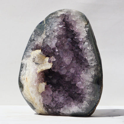 Meditation inviting, exclusive cathedral shaped violet amethyst. With delightful calcite formation the polished edges expose jasper, blue agate, and white quartz.